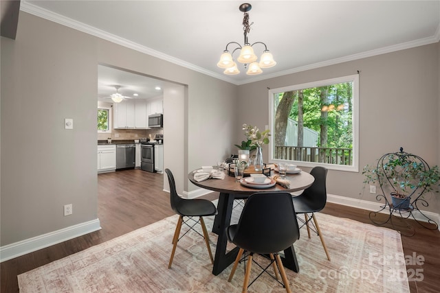 dining space with baseboards, healthy amount of natural light, a chandelier, wood finished floors, and ornamental molding