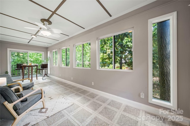 sunroom with baseboards and crown molding