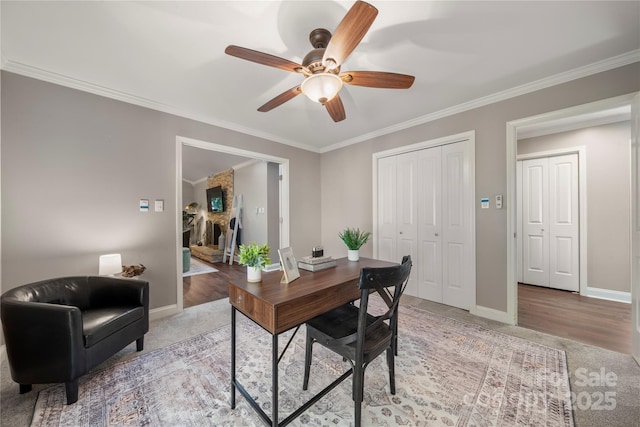 office with ceiling fan, crown molding, baseboards, and light colored carpet