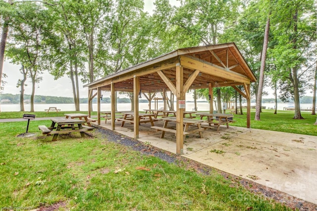 view of community featuring a gazebo, a yard, and a water view