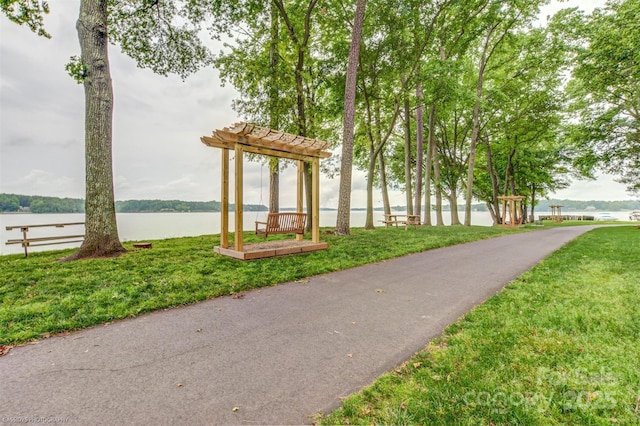 view of property's community featuring a water view and a lawn