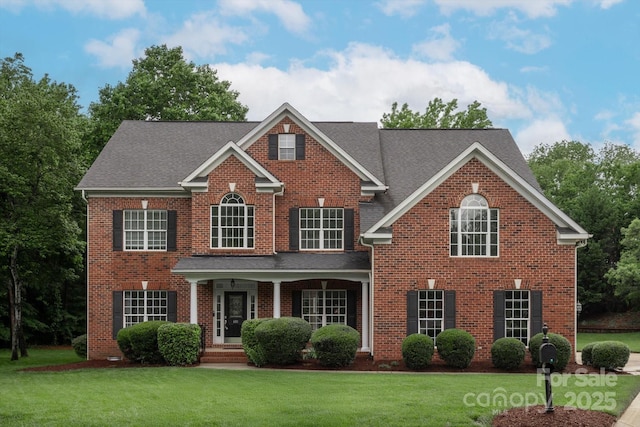 601 Carver Pond Ln, Waxhaw, NC 28173 - view of front of property with a front lawn, brick siding, and roof with shingles