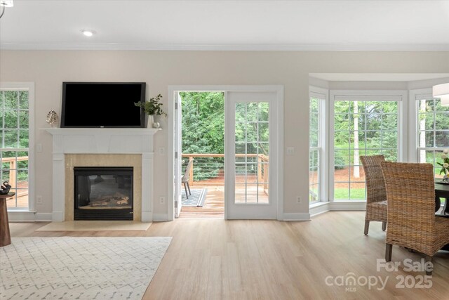 601 Carver Pond Ln, Waxhaw, NC 28173 - living room featuring a fireplace, wood finished floors, plenty of natural light, and crown molding