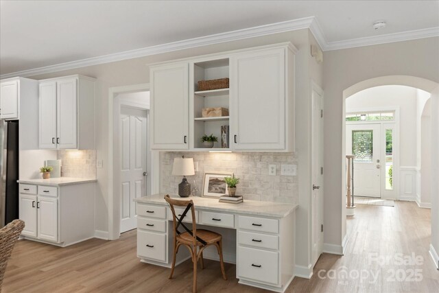 601 Carver Pond Ln, Waxhaw, NC 28173 - office space featuring arched walkways, light wood-type flooring, ornamental molding, and built in study area