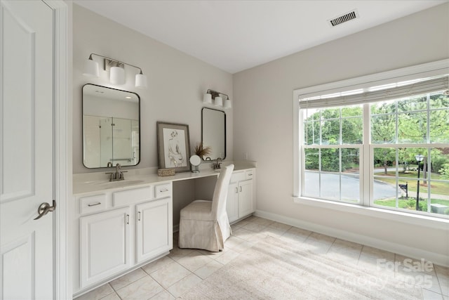 601 Carver Pond Ln, Waxhaw, NC 28173 - bathroom featuring tile patterned floors, double vanity, a shower, and baseboards