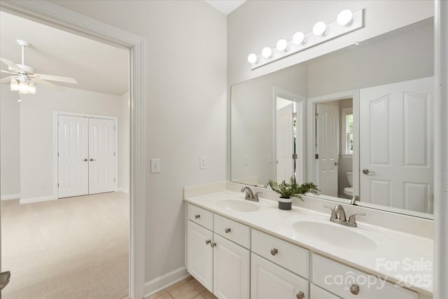 601 Carver Pond Ln, Waxhaw, NC 28173 - bathroom with toilet, a ceiling fan, baseboards, and double vanity