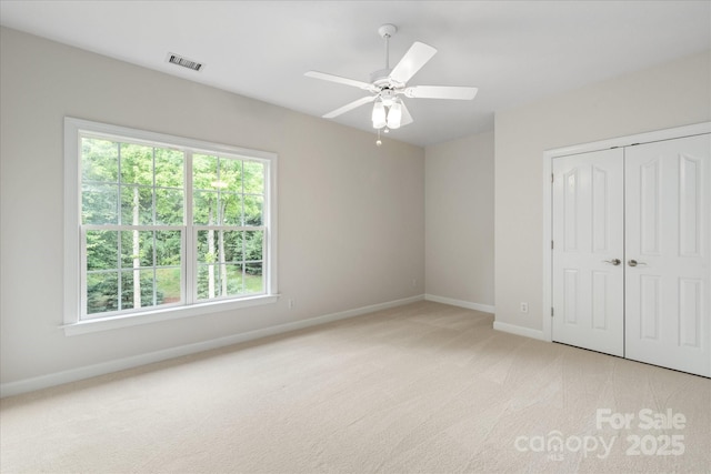601 Carver Pond Ln, Waxhaw, NC 28173 - unfurnished bedroom with baseboards, light carpet, multiple windows, and a closet
