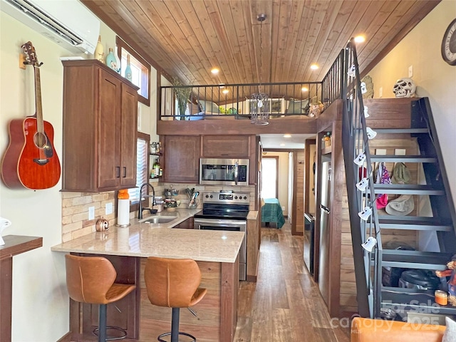 150 Easy St, Hot Springs, NC 28743 - kitchen with appliances with stainless steel finishes, a sink, wood ceiling, an AC wall unit, and a peninsula