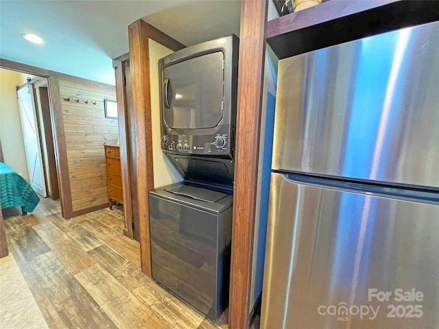 150 Easy St, Hot Springs, NC 28743 - laundry area featuring estacked washer and dryer, wood finished floors, and wood walls