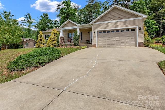view of front of house featuring a porch, driveway, and an attached garage