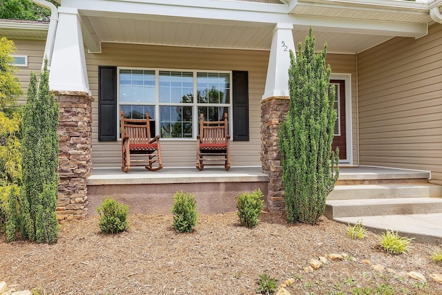 view of exterior entry featuring a porch