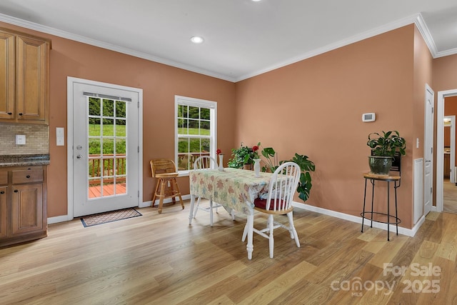 dining room featuring ornamental molding, light wood-type flooring, baseboards, and recessed lighting