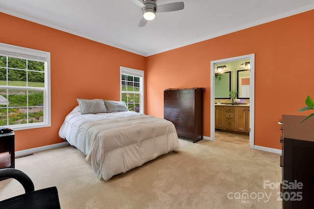 bedroom featuring crown molding, light carpet, multiple windows, and baseboards