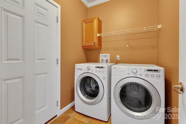 clothes washing area featuring washer and clothes dryer, cabinet space, crown molding, and baseboards