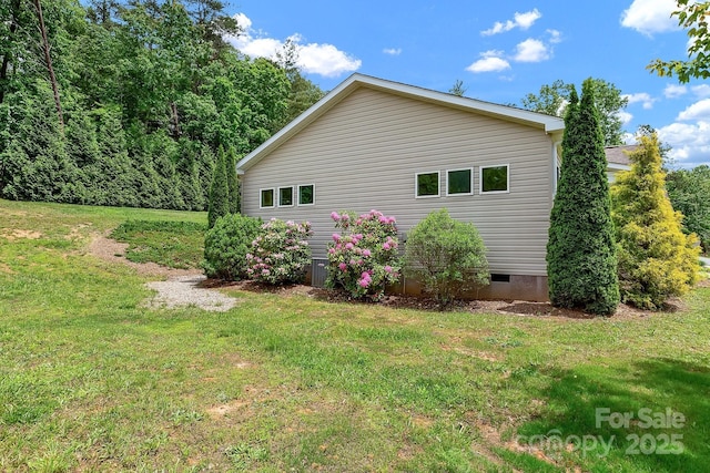 view of home's exterior featuring a lawn and crawl space