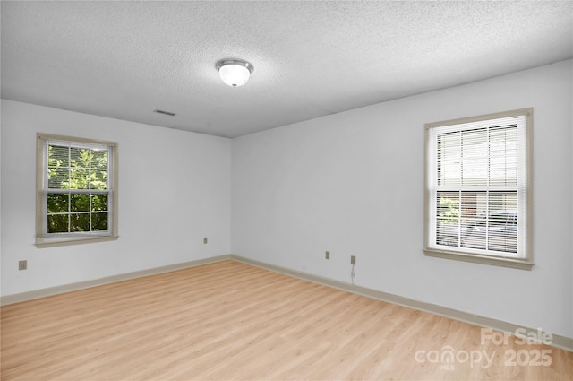 4738 Truscott Rd, Charlotte, NC 28226 - empty room featuring wood finished floors, a textured ceiling, and baseboards