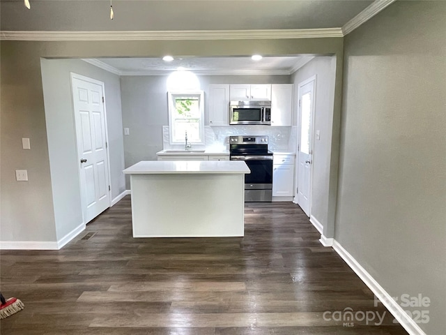 1052 S Grove Street Ext, Lincolnton, NC 28092 - kitchen featuring stainless steel appliances, dark wood-type flooring, crown molding, white cabinets, and baseboards