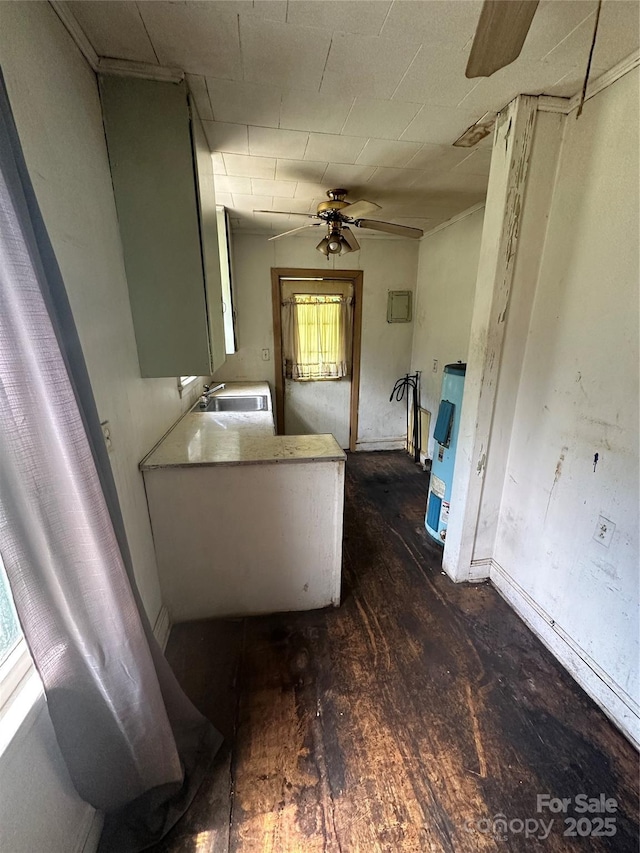bathroom featuring hardwood / wood-style floors, a ceiling fan, gas water heater, a sink, and baseboards