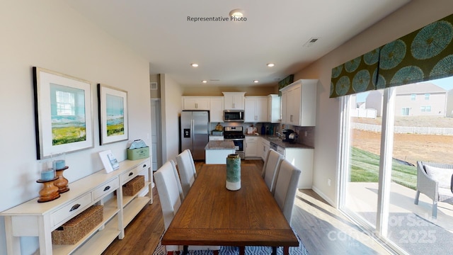 dining space featuring dark wood-style floors and recessed lighting