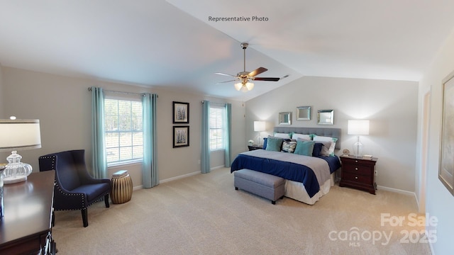 bedroom featuring vaulted ceiling, light carpet, baseboards, and a ceiling fan