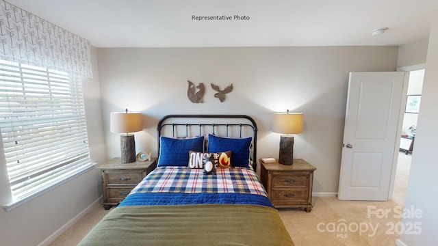 bedroom featuring carpet flooring, multiple windows, and baseboards