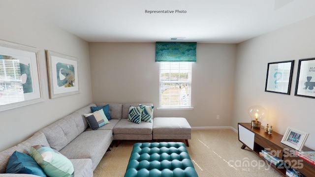 living room featuring light carpet and baseboards