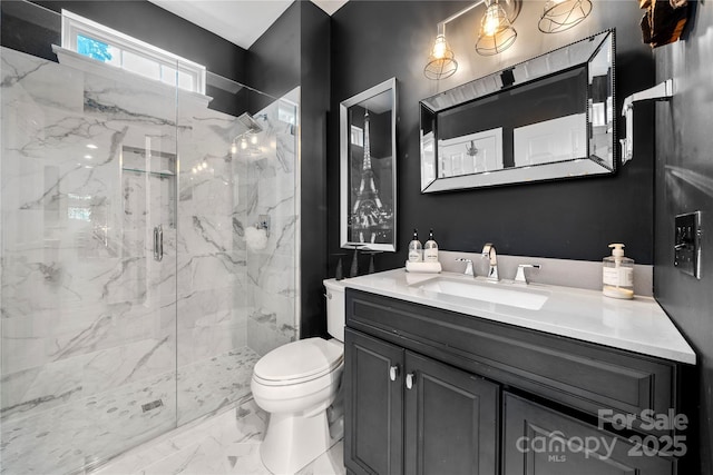 bathroom featuring a marble finish shower, toilet, marble finish flooring, and vanity