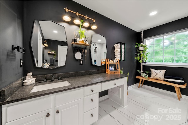 bathroom with vanity and baseboards