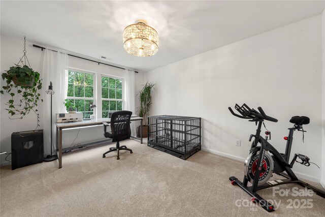 carpeted office space with a chandelier