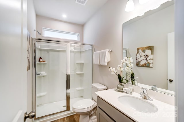 2636 Tillman St, Monroe, NC 28112 - bathroom with a stall shower, toilet, vanity, and wood finished floors
