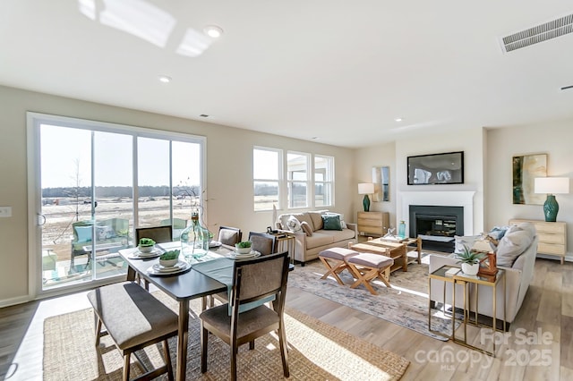 2636 Tillman St, Monroe, NC 28112 - living area featuring light wood-style floors, a glass covered fireplace, and recessed lighting