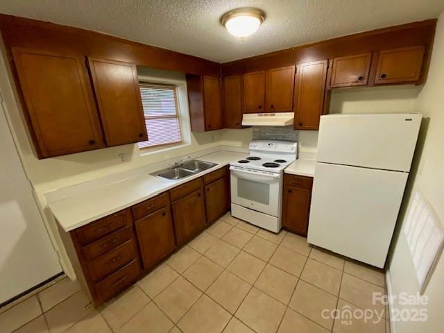 5309 Lewis Rd, Gastonia, NC 28052 - kitchen with white appliances, a sink, under cabinet range hood, a textured ceiling, and light countertops