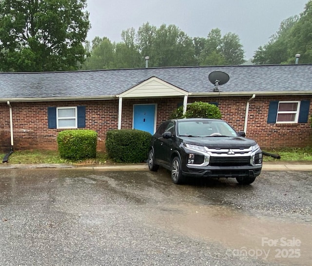 5309 Lewis Rd, Gastonia, NC 28052 - ranch-style house featuring brick siding, a shingled roof, and uncovered parking