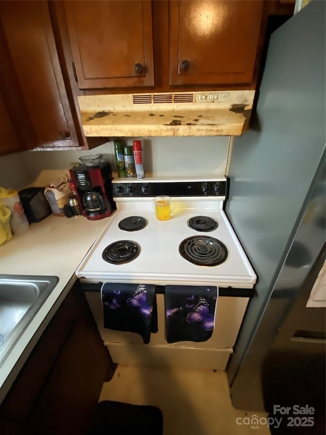 5309 Lewis Rd, Gastonia, NC 28052 - kitchen featuring under cabinet range hood, white electric stove, light countertops, and a sink