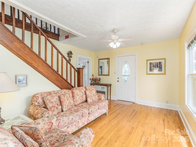 10 Gardening Frog Trl, Waynesville, NC 28785 - living room with light wood-type flooring, baseboards, stairs, a textured ceiling, and ceiling fan