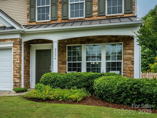 3224 Dunbar Ln, Fort Mill, SC 29707 - entrance to property with a standing seam roof, stone siding, a garage, covered porch, and metal roof
