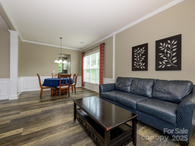 3224 Dunbar Ln, Fort Mill, SC 29707 - living room featuring dark wood finished floors, crown molding, a chandelier, decorative columns, and a wainscoted wall