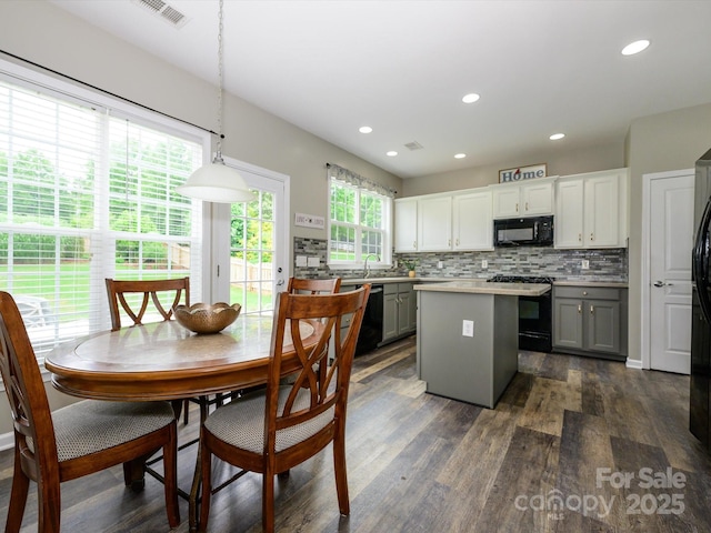 3224 Dunbar Ln, Fort Mill, SC 29707 - kitchen featuring black appliances, gray cabinets, a center island, decorative backsplash, and dark wood-type flooring