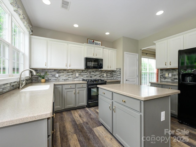 3224 Dunbar Ln, Fort Mill, SC 29707 - kitchen with black appliances, a sink, gray cabinetry, tasteful backsplash, and dark wood-style floors