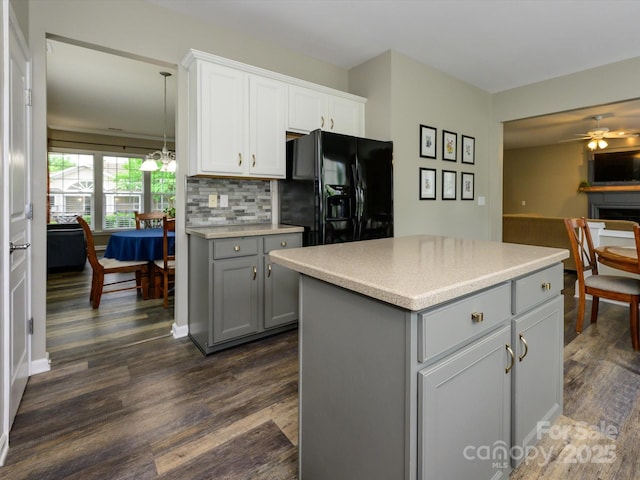 3224 Dunbar Ln, Fort Mill, SC 29707 - kitchen featuring black fridge with ice dispenser, gray cabinetry, dark wood-style floors, tasteful backsplash, and light countertops