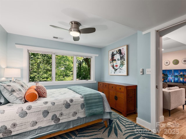 11 Kenilworth Rd, Asheville, NC 28803 - bedroom with light wood finished floors, ceiling fan, and baseboards