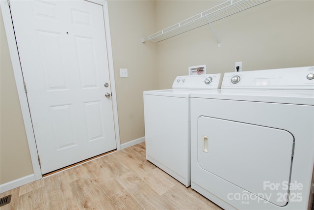 3499 Fairview Rd, Nebo, NC 28761 - washroom featuring separate washer and dryer, light wood-type flooring, and baseboards