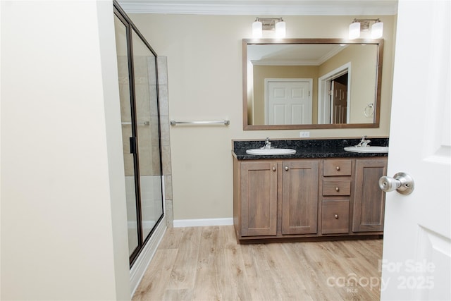 3499 Fairview Rd, Nebo, NC 28761 - bathroom featuring wood finished floors, a shower stall, crown molding, and double vanity