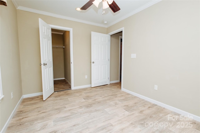 3499 Fairview Rd, Nebo, NC 28761 - unfurnished bedroom with light wood-style flooring, crown molding, a walk in closet, and baseboards