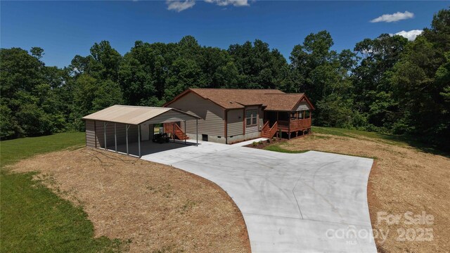 3499 Fairview Rd, Nebo, NC 28761 - view of front facade featuring a carport, concrete driveway, a front yard, crawl space, and a wooden deck