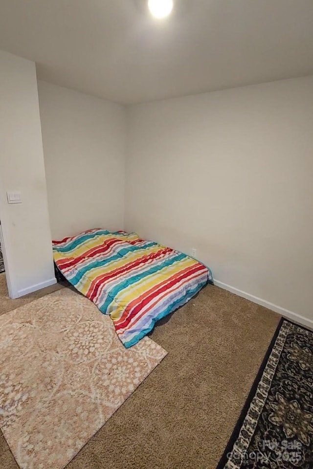 carpeted bedroom with baseboards