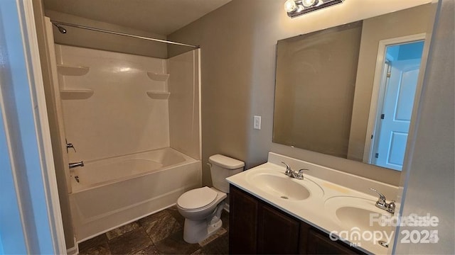5823 Natick Dr, Charlotte, NC 28214 - full bathroom with toilet, double vanity, tub / shower combination, and stone finish floors