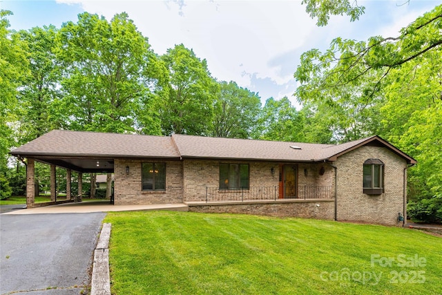 109 Wilkie Way, Fletcher, NC 28732 - ranch-style home featuring brick siding, asphalt driveway, a front lawn, and an attached carport