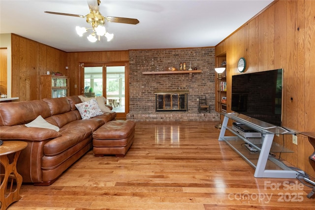 109 Wilkie Way, Fletcher, NC 28732 - living area with wooden walls, light wood-type flooring, ceiling fan, and a fireplace