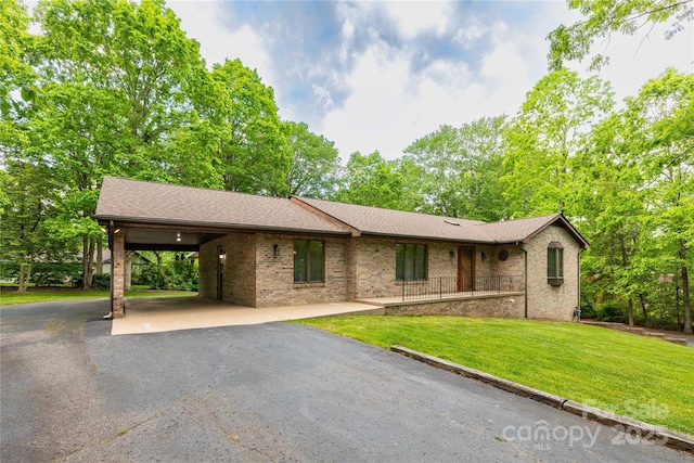 109 Wilkie Way, Fletcher, NC 28732 - single story home featuring driveway, a front lawn, brick siding, roof with shingles, and an attached carport